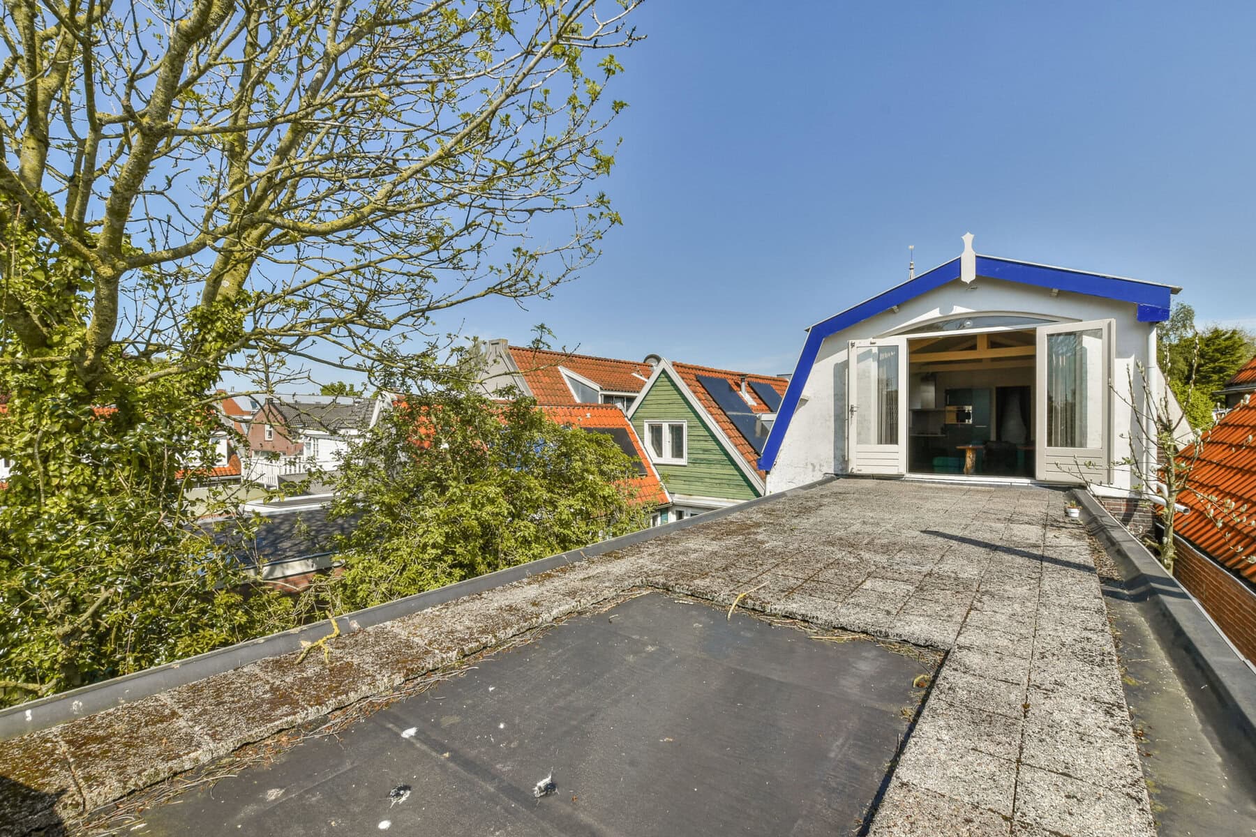 Rooftop of Sloterweg 1257 in Amsterdam with cityscape and greenery.