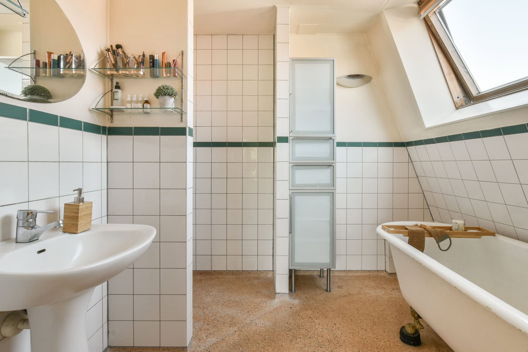 Bright bathroom with bathtub, sink, and skylight at Sloterweg 1257 Amsterdam.